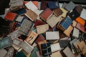 brown and white books on brown wooden table