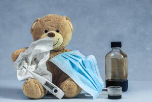 brown bear plush toy on blue textile