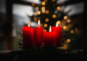 shallow focus photo of four red lighted candles